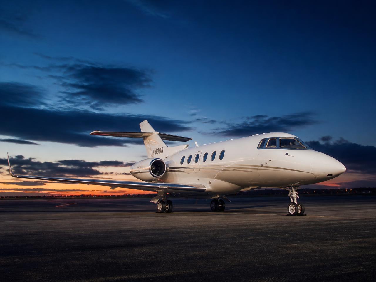 Hawker 900XP midsize private jet on the tarmac at dusk